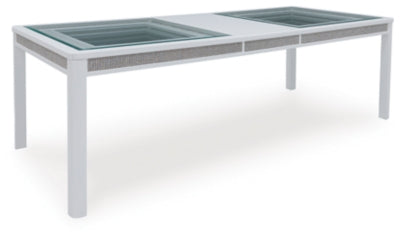 Ashley Furniture Chalanna dining extension table with leaf, shown from an angled side view, showcasing its wood finish and design.