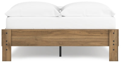 Ashley Furniture Deanlow Bed with a sturdy wooden frame and classic design, shown in a cozy bedroom setting.
