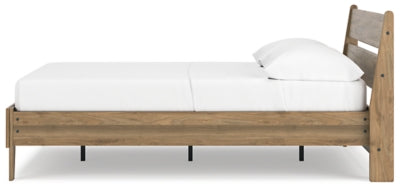 Ashley Furniture Deanlow Bed with a sturdy wooden frame and classic design, shown from a side angle in natural wood finish.