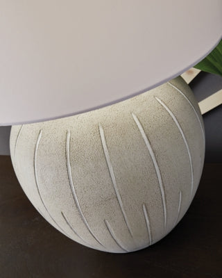 Ashley Furniture Calbert table lamp with a sleek base and fabric shade, perfect for modern home decor.
