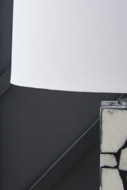 Close-up of the shade detail on the Macaria table lamp by Ashley Furniture, showcasing its elegant design and fabric texture.