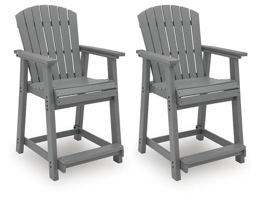Set of two Ashley Furniture Sanctuary Beach outdoor counter height bar stools with metal frames and woven seats.