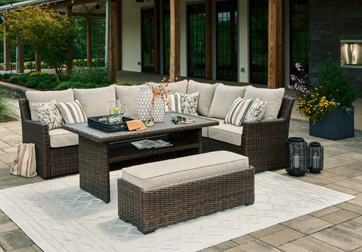 Outdoor seating set from Ashley Furniture’s Brook Ranch Outdoor Package, featuring cushioned chairs and a matching table in a patio setting.
