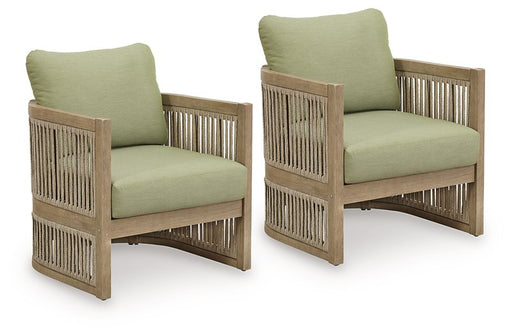 Set of two Ashley Furniture Serena Shores outdoor lounge chairs with cushioned seats and woven rattan-style frames.