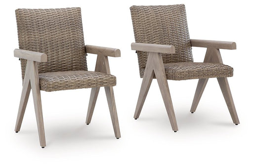 Set of two Ashley Furniture Cliff Trails outdoor dining arm chairs with woven seats and armrests, suitable for patio or garden use.