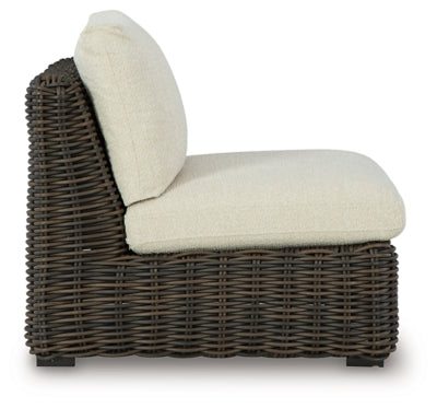 Ashley Furniture Kimora outdoor sectional with beige cushions and dark wicker frame, shown on patio setting.