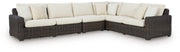 Kimora outdoor sectional by Ashley Furniture featuring plush cushions and a stylish outdoor seating arrangement.