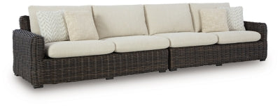 Ashley Furniture Kimora outdoor sectional with weather-resistant cushions and stylish wicker frame, perfect for patio seating.