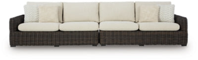 Ashley Furniture Kimora outdoor sectional with beige cushions and dark wicker frame, designed for stylish outdoor seating.