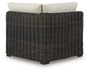 Kimora outdoor sectional by Ashley Furniture with plush cushions and wicker frame, designed for comfortable outdoor seating.
