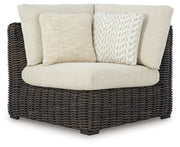 Ashley Furniture Kimora outdoor sectional with plush cushions, modern outdoor seating arrangement on a patio.