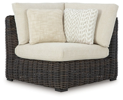 Ashley Furniture Kimora outdoor sectional with plush cushions, modern outdoor seating arrangement on a patio.