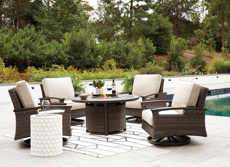 Outdoor seating set featuring a Paradise Trail fire pit table with four Nuvella swivel lounge chairs by Ashley Furniture.